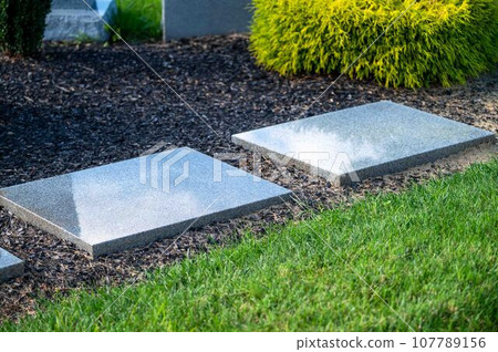 Two new unmarked grave stones side by side in nice cemetery Two new unmarked grave stones side by side in nice cemetery 107789156