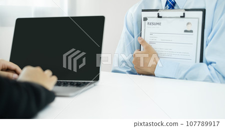 Business people hold a resume and talk to job applicants for job interviews about careers and Their personal history in the company. Recruitment concepts 107789917