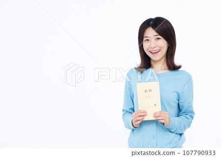A woman in her 30s holding a salary bag in front of a white background A woman in her 30s holding a salary bag in front of a white background 107790933