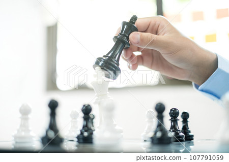 hand of businessmen moving chess in competition shows leadership, followers and business success strategies 107791059