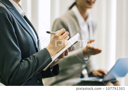A woman taking notes during a meeting/business negotiation 107791301