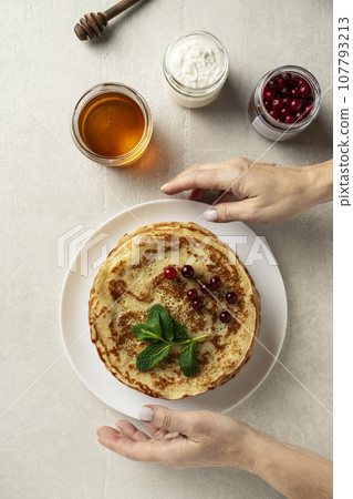Large pancakes on light stone background Large pancakes on light stone background 107793213