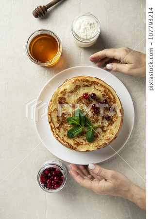 Large pancakes on light stone background Large pancakes on light stone background 107793214