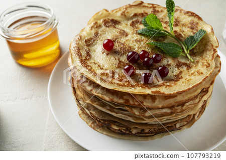 Large pancakes on light stone background Large pancakes on light stone background 107793219