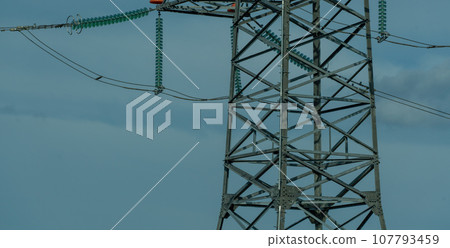 High voltage towers with sky background. Power line support with wires for electricity transmission. High voltage grid tower with wire cable at distribution station. Energy industry, energy saving 107793459