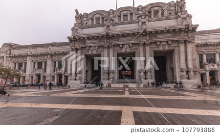 Panorama showing Milano Centrale timelapse - the main central railway station of the city of Milan in Italy. Panorama showing Milano Centrale timelapse - the main central railway station of the city of Milan in Italy. 107793888