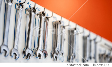 Combination wrench spanner hanging on storage board 107794183