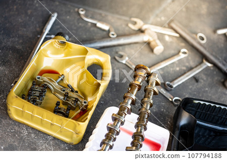 Auto parts in gallon cut in half with mechanical tools 107794188