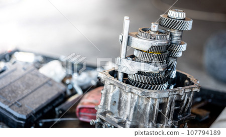 Car automatic transmission gear part on workbench in garage Car automatic transmission gear part on workbench in garage 107794189