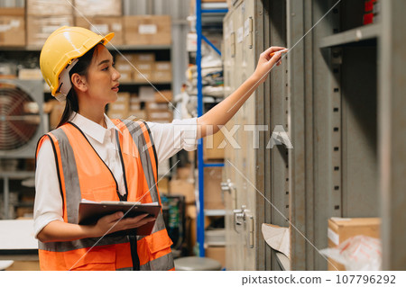 Engineer woman work in hardware products warehouse store using tablet parts inventory management software 107796292