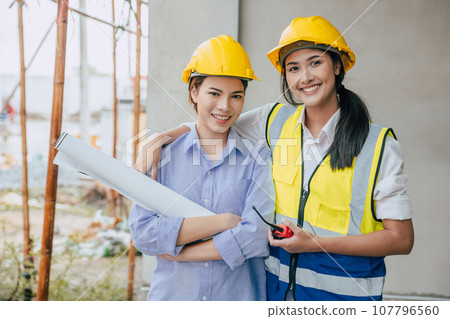 Portrait happy smiling construction Engineer women working team together builder architect designer work at construction site Portrait happy smiling construction Engineer women working team together builder architect designer work at construction site 107796560