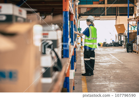 Warehouse worker staff working products inventory check in shipping delivery stock cargo goods storage. 107796590