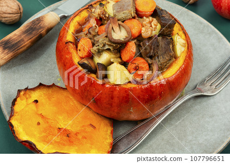 Tasty baked pumpkin with beef, mushrooms and apples. Tasty baked pumpkin with beef, mushrooms and apples. 107796651