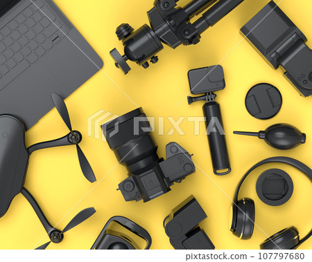 Top view of monochrome designer workspace and photography gear on yellow Top view of monochrome designer workspace and photography gear on yellow 107797680
