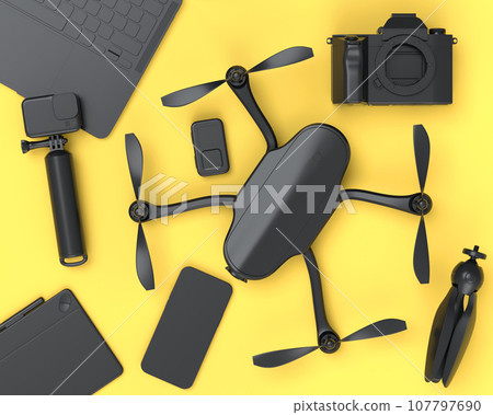 Top view of monochrome designer workspace and photography gear on yellow 107797690