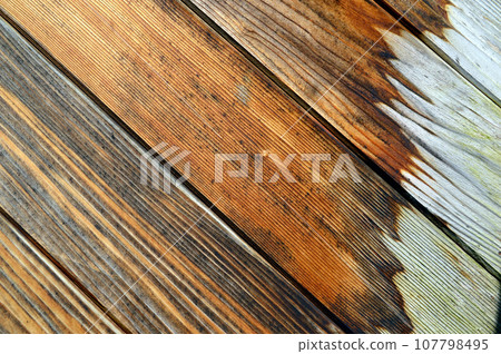 Wooden wall made of diagonal boards with white painted spots. background 107798495