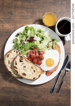One plate breakfast, coffee and orange juice One plate breakfast, coffee and orange juice 107798546