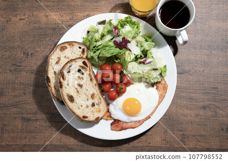 One plate breakfast, coffee and orange juice One plate breakfast, coffee and orange juice 107798552