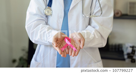 Pink October Breast Cancer Awareness month, doctor with pink ribbon symbol. National cancer survivors month. health care concept 107799227