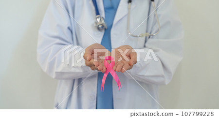 Pink October Breast Cancer Awareness month, doctor with pink ribbon symbol. National cancer survivors month. health care concept 107799228