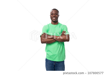 young positive 30 year old American guy dressed casually in a basic t-shirt and jeans 107800577