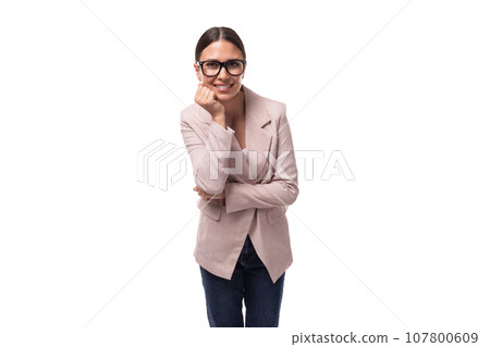young smart brunette with hair gathered in a ponytail is dressed in a light jacket on a white 107800609