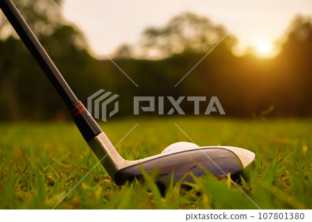 Golf ball and golf club in beautiful golf course at sunset background. 107801380