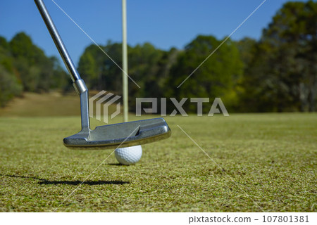 Golf ball and golf club in beautiful golf course at sunset background. 107801381
