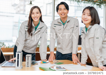 A group of young engineers in work clothes A group of young engineers in work clothes 107801471