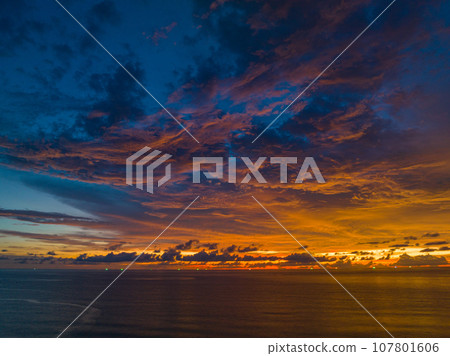 .amazing colorful orange cloud above the ocean in sunset 107801606