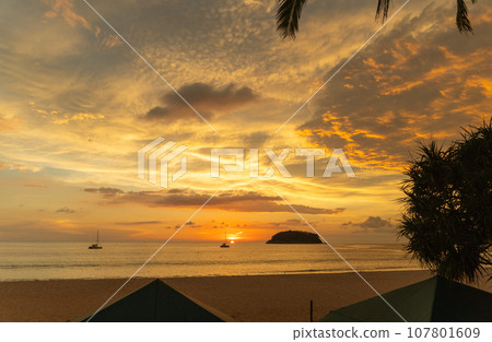 .beautiful cloud in golden sky at sunset in Kata beach Phuket Thailand. 107801609