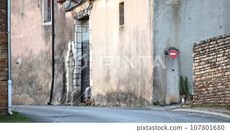 View over a small road through a French village View over a small road through a French village 107801680