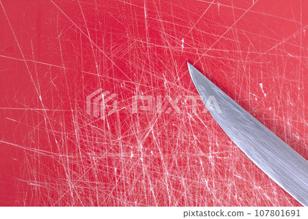 Color gradient red old plastic cutting board background with scratches Color gradient red old plastic cutting board background with scratches 107801691