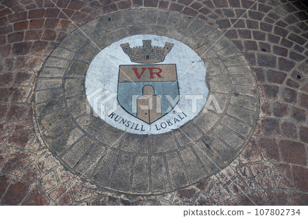Malta, Gozo, Coat of arms formed from paving stones on the ground of the town of Victoria 107802734