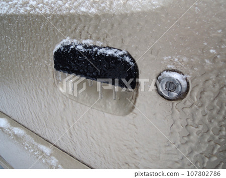 Frozen Keyhole And Icicles On Handle Of Vehicle Door Angle View Stock Photo Frozen Keyhole And Icicles On Handle Of Vehicle Door Angle View Stock Photo 107802786