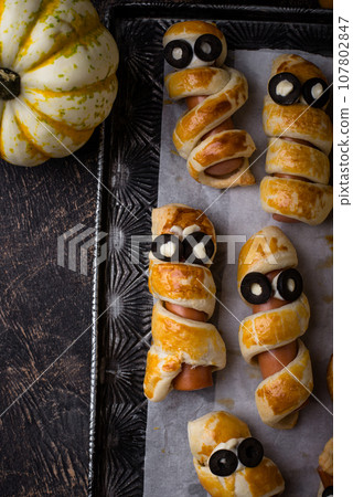 Halloween food. Ssausage in shape of mummies 107802847