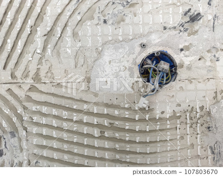 Abstract background of an old wall with fragments of the texture of the adhesive Abstract background of an old wall with fragments of the texture of the adhesive 107803670