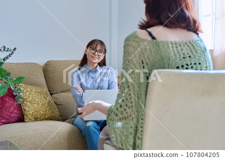 Young woman at mental therapy session with female psychologist, in office 107804205