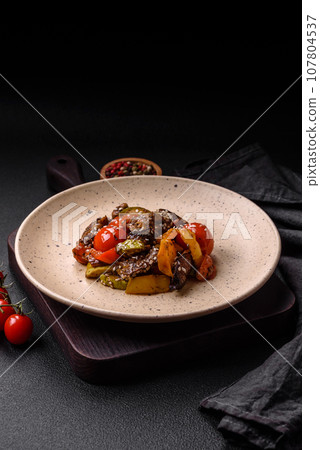 Warm salad with veal, tomatoes, peppers, zucchini, sesame, salt, spices and herbs 107804537