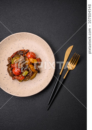 Warm salad with veal, tomatoes, peppers, zucchini, sesame, salt, spices and herbs Warm salad with veal, tomatoes, peppers, zucchini, sesame, salt, spices and herbs 107804548