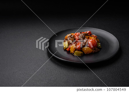 Warm salad with veal, tomatoes, peppers, zucchini, sesame, salt, spices and herbs Warm salad with veal, tomatoes, peppers, zucchini, sesame, salt, spices and herbs 107804549