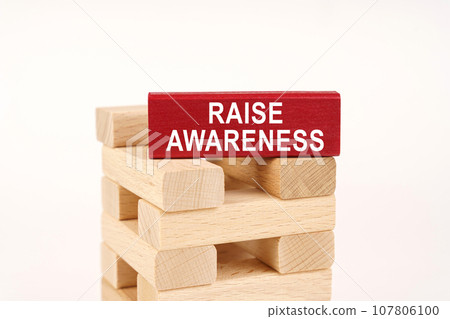 On the wooden planks there is a red one with the inscription - Raise Awareness On the wooden planks there is a red one with the inscription - Raise Awareness 107806100