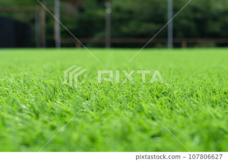 Artificial grass close-up. Artificial turf background. Artificial grass close-up. Artificial turf background. 107806627