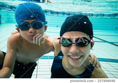 swimming coach and student swimming coach and student 107806696