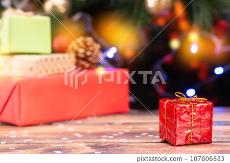 Christmas scene with tree gifts and fire in background 107806883