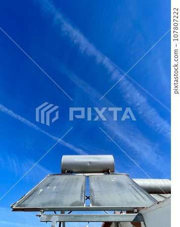 Solar water heater installed on tile roof of house for environmentally 107807222