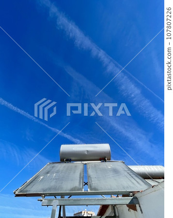 Solar water heater installed on tile roof of house for environmentally 107807226