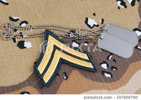 May 12, 2018. US ARMY Corporal rank patch and dog tags on desert camouflage uniform May 12, 2018. US ARMY Corporal rank patch and dog tags on desert camouflage uniform 107808700