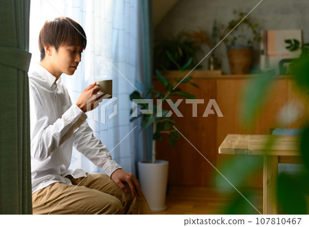 Man drinking coffee Man drinking coffee 107810467