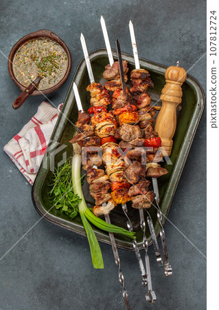 Bbq grilled meat pork, chicken and vegetable skewers on tray. Top view, flat lay Bbq grilled meat pork, chicken and vegetable skewers on tray. Top view, flat lay 107812724